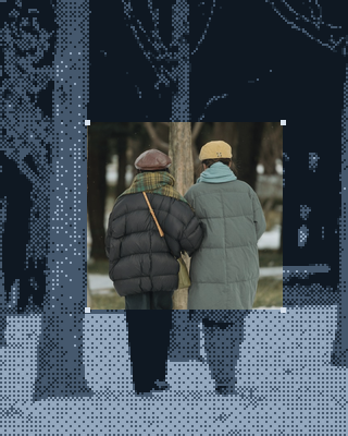 Un couple âgé marche bras dessus, bras dessous dans la neige.